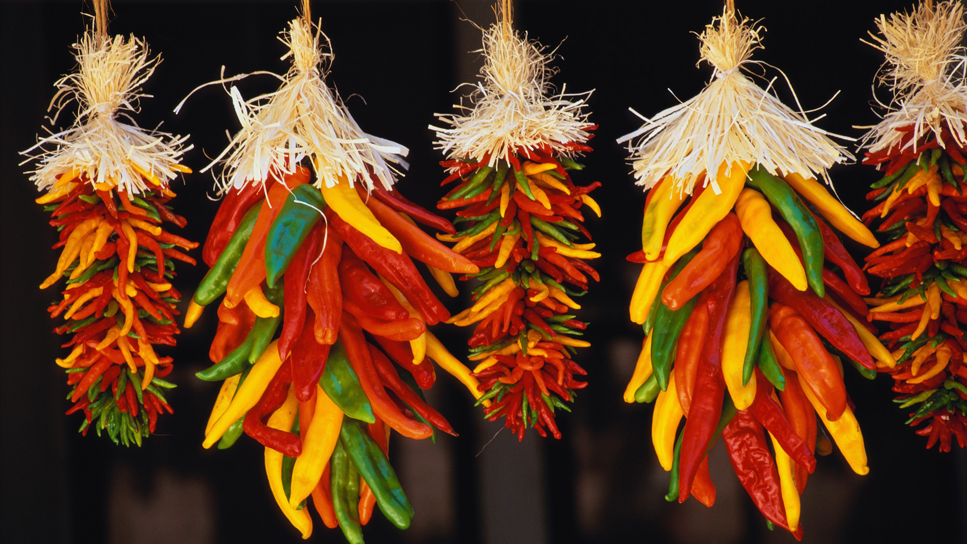 ca. 1980-2001, Hatch, New Mexico, USA --- Hanging Chili Peppers --- Image by © Catherine Karnow/CORBIS